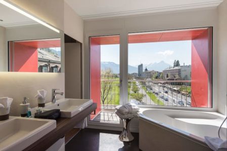 View onto the Höhematte from the bathroom int the Panoramic Junior Suite at Hotel du Nord in Interlaken Switzerland